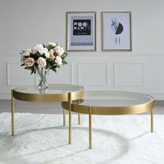 two tables with flowers in vases on top of white carpeted floor next to wall