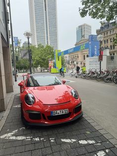 a red sports car is parked on the street