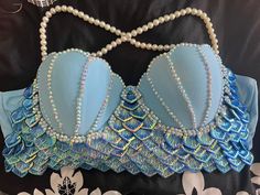 a blue bra with pearls and beads on it