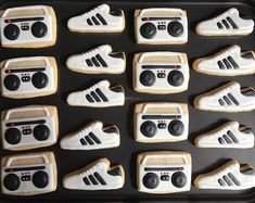 decorated cookies in the shape of tennis shoes and sneakers are arranged on a baking sheet