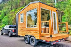 a truck is towing a tiny house on the back of it's flatbed