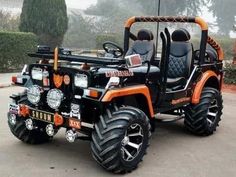 an orange and black four - wheeled vehicle parked in a parking lot