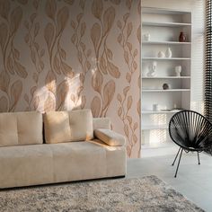 a white couch sitting next to a chair on top of a rug in a living room