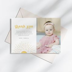 a thank card with an image of a baby in a pink dress and sunburst