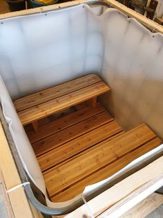 a wooden bench sitting inside of a metal container