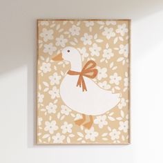 a white duck with an orange ribbon on it's neck is standing in front of a flowered background