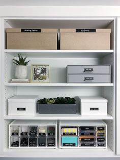 the shelves are organized with boxes, file folders and other office supplies on them