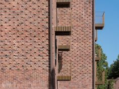 a tall brick building with balconies on the second floor