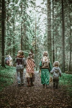 three children walking down a path in the woods