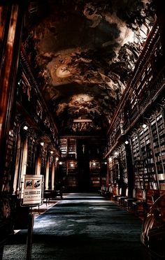 an empty library with many bookshelves and lights on the ceiling is pictured in this image