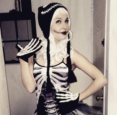 a woman dressed in skeleton costume posing for the camera