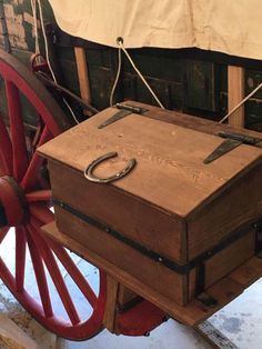 an old wooden box sitting on top of a wagon