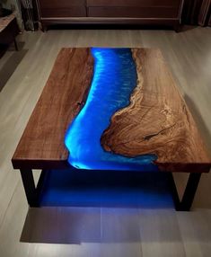 a wooden table with blue water on it in a living room next to a couch