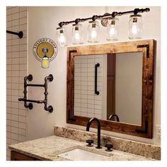 a bathroom with a sink, mirror and soap dispenser on the wall