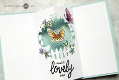 an open card with butterflies on it and the words have a lovely day written in black ink