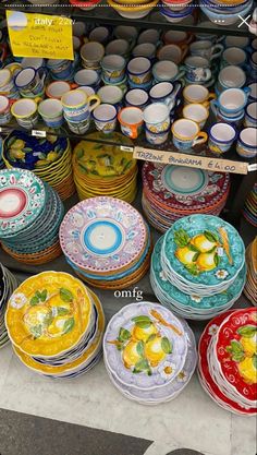 colorful plates and bowls are on display for sale