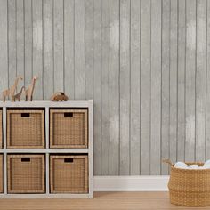 an empty room with four wicker baskets on the floor