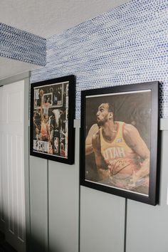 three framed sports photos hang on the wall next to each other in a room with blue and white tile