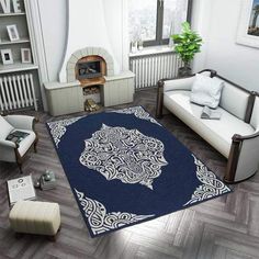 a living room filled with furniture and a blue rug on top of a hard wood floor