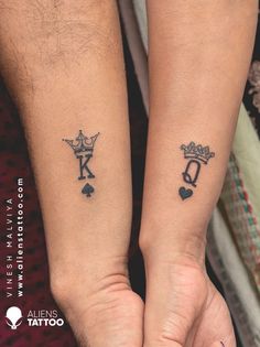 two people with matching tattoos on their arms, both holding each other's hands