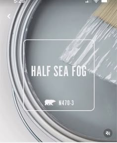 a paint can with the words half sea fog painted on it and a brush inside