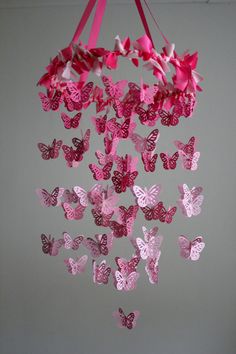 a mobile with pink butterflies hanging from it