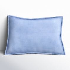 a blue pillow sitting on top of a white wall