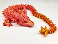 an origami dragon is laying on the ground