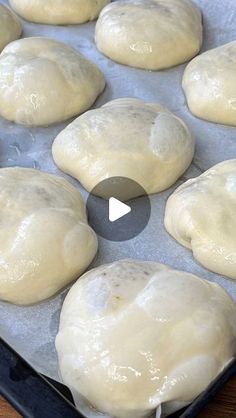 uncooked bread rolls on a baking sheet ready to go into the oven in an oven