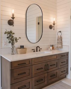 a bathroom with two sinks and a large mirror on the wall over it's counter