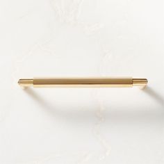 a gold handle on a white wall