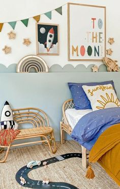 a child's bedroom with toys on the floor, and a rocket ship bed