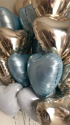 a bunch of silver and blue heart shaped balloons