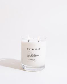 a white candle sitting on top of a table