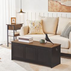 a living room with a couch, coffee table and lamp on the end tables in front of it