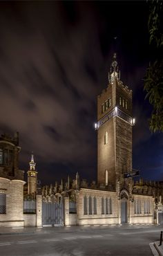 a large clock tower towering over a city at night