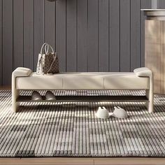 a white bench sitting on top of a rug in front of a wooden wall with a clock above it