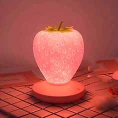 a strawberry shaped light sitting on top of a table