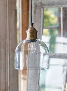 a clear glass light fixture hanging from a ceiling