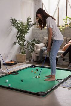 two people playing mini golf in the living room