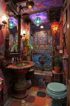 a colorful bathroom with an ornate sink and toilet