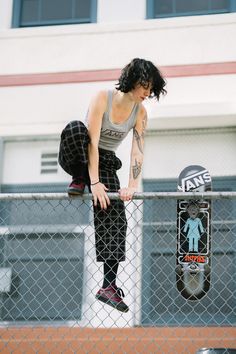 a person on a skateboard doing a trick over a fence