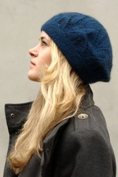 a woman with long blonde hair wearing a blue hat