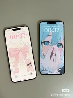 two cell phones sitting next to each other on top of a white surface with anime characters