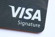 a visa card sitting on top of a white table