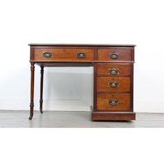 an old wooden desk with three drawers