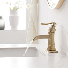 a faucet with water running from it's spout in a bathroom