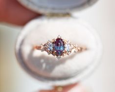 a close up of a ring with a blue and white stone in it's center