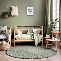 a baby's room with two cribs, a rug and pictures on the wall