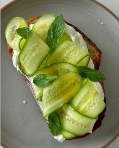 a sandwich with cucumbers and mint on it